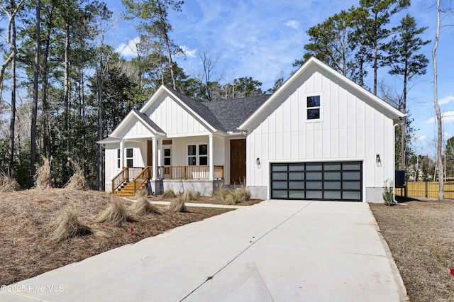 modern inspired farmhouse featuring covered porch, board and batten siding, concrete driveway, roof with shingles, and a garage