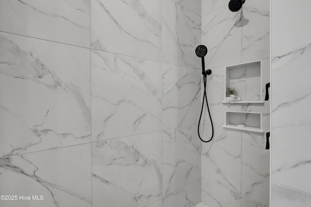 room details featuring a marble finish shower