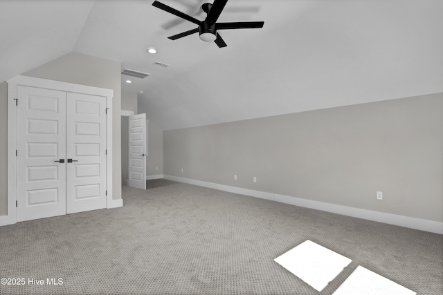 additional living space featuring lofted ceiling, carpet, and visible vents