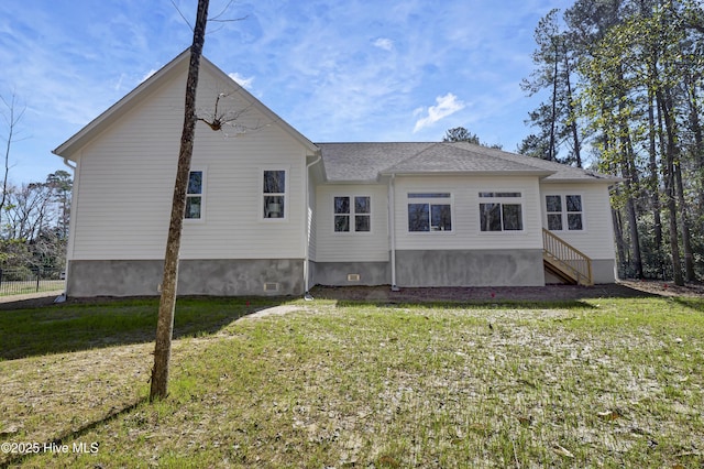 back of house with a lawn and crawl space