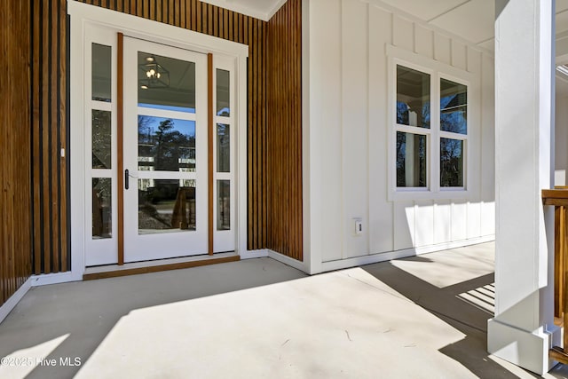 property entrance featuring board and batten siding