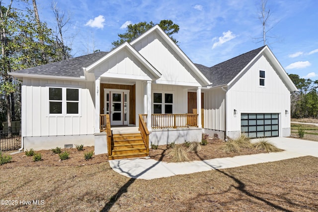 modern inspired farmhouse featuring driveway, a porch, board and batten siding, a shingled roof, and crawl space