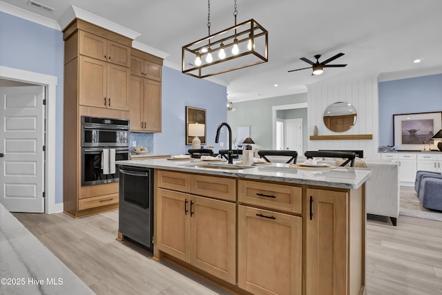 kitchen with visible vents, open floor plan, double wall oven, ornamental molding, and a sink