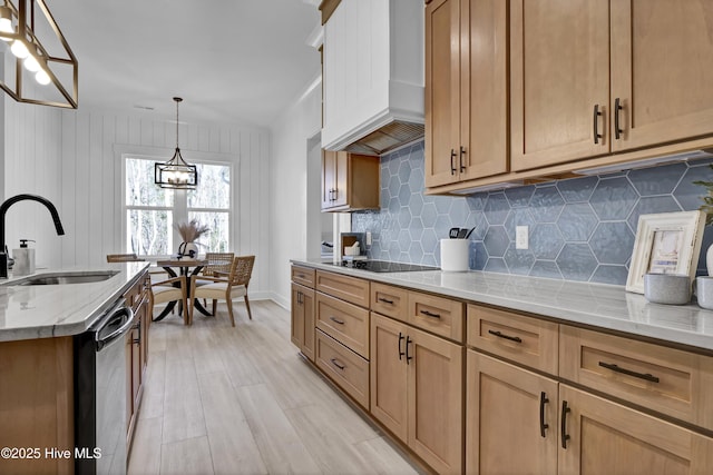 kitchen featuring light stone countertops, premium range hood, a sink, dishwasher, and black electric cooktop