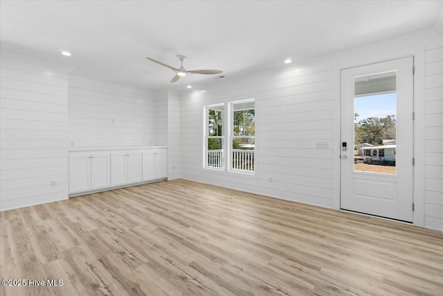 empty room with recessed lighting, a ceiling fan, and light wood finished floors