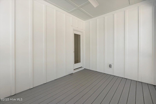 empty room featuring a decorative wall and hardwood / wood-style flooring