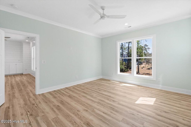 unfurnished room featuring baseboards, crown molding, light wood-style floors, and a ceiling fan