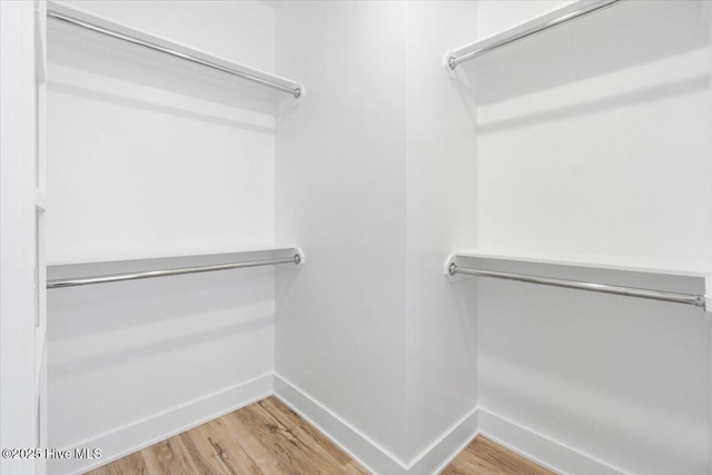 spacious closet with wood finished floors