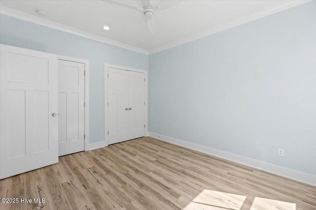 unfurnished bedroom featuring crown molding, recessed lighting, baseboards, ceiling fan, and wood finished floors
