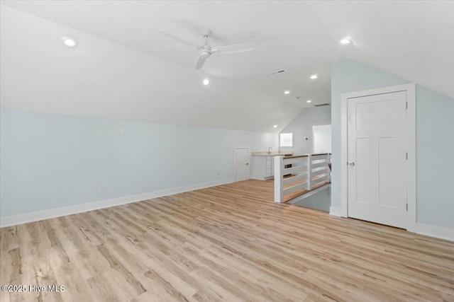 bonus room featuring a ceiling fan, baseboards, lofted ceiling, and light wood-type flooring
