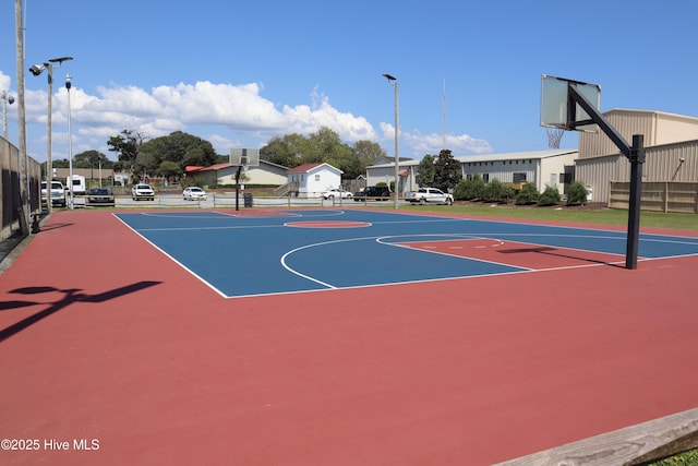 view of basketball court featuring community basketball court and fence