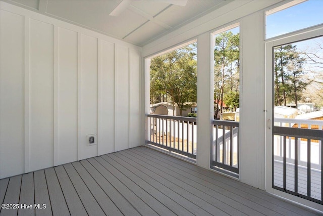 wooden terrace featuring a shed and an outdoor structure