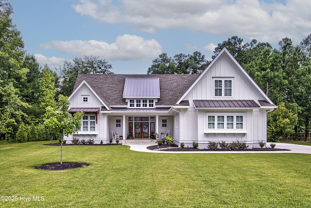 modern farmhouse featuring roof with shingles, a standing seam roof, a front lawn, french doors, and board and batten siding