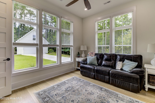 living room featuring ceiling fan, visible vents, wood finished floors, and recessed lighting