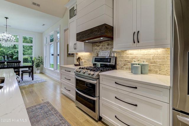 kitchen with visible vents, appliances with stainless steel finishes, white cabinets, and light wood finished floors