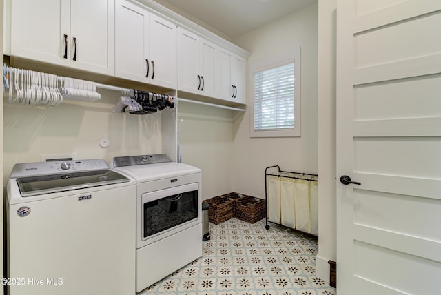 laundry room featuring washer and dryer, cabinet space, and light floors