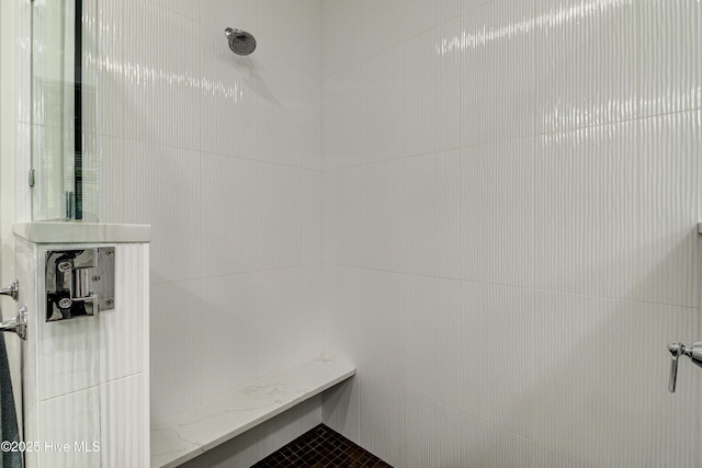 bathroom with a tile shower