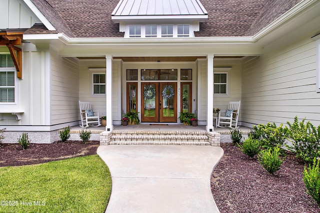 doorway to property with a porch, french doors, board and batten siding, and roof with shingles