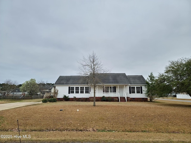 single story home featuring roof with shingles, driveway, and crawl space