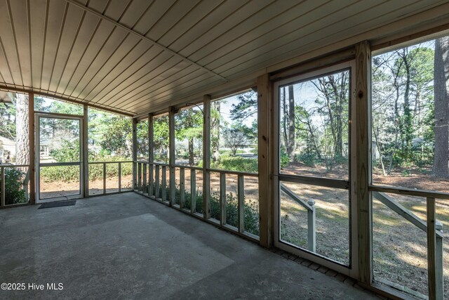 unfurnished sunroom with lofted ceiling