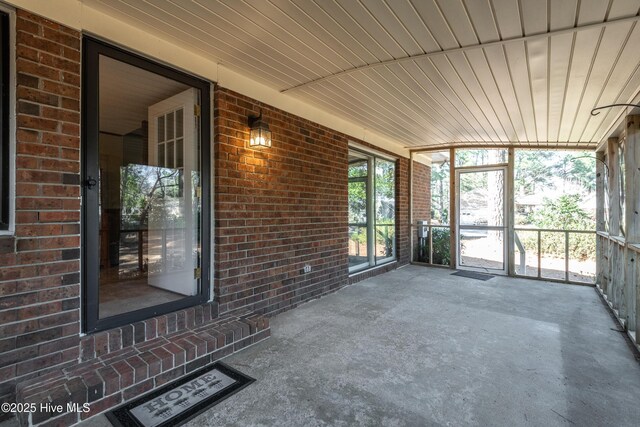 unfurnished sunroom with wooden ceiling