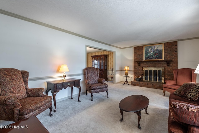 carpeted living room with a textured ceiling, a fireplace, and ornamental molding