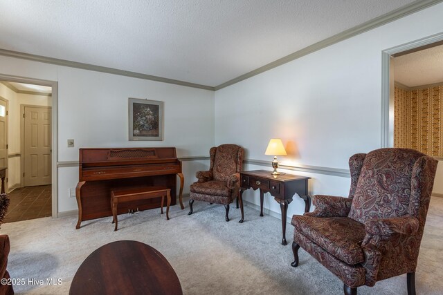 living area with baseboards, a textured ceiling, crown molding, and carpet