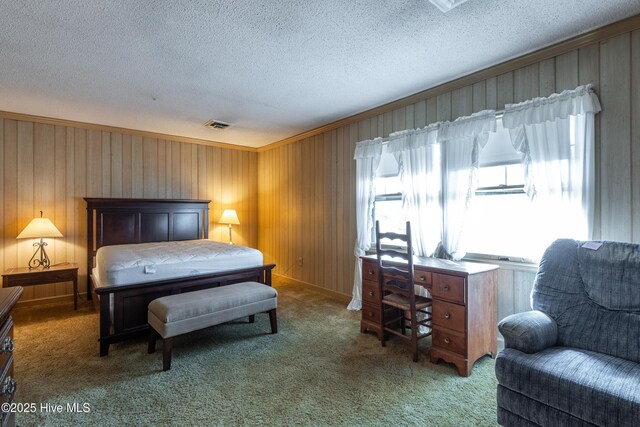 bedroom with ornamental molding, carpet floors, and a textured ceiling