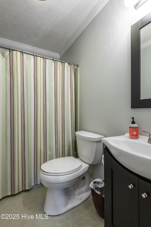 bathroom with tile patterned floors, toilet, vanity, and ornamental molding