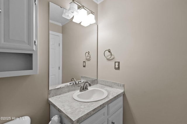 half bathroom featuring toilet, vanity, and crown molding