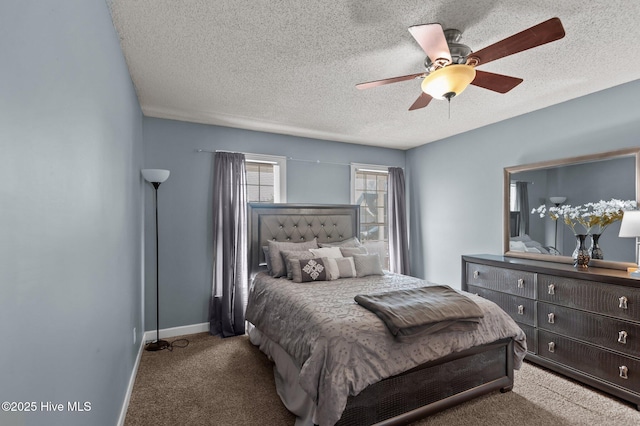 bedroom with ceiling fan, baseboards, carpet floors, and a textured ceiling