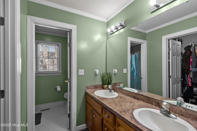 full bath with a textured ceiling, ornamental molding, visible vents, and a sink