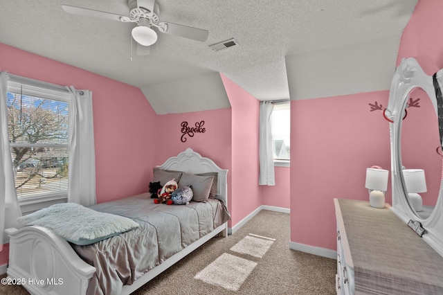 bedroom with visible vents, baseboards, vaulted ceiling, carpet floors, and a textured ceiling