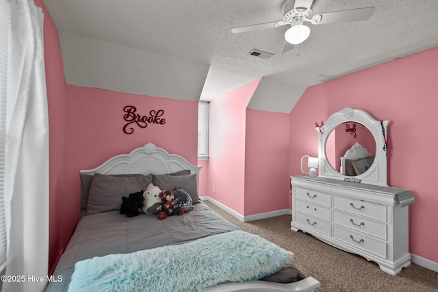 carpeted bedroom featuring visible vents, a textured ceiling, baseboards, ceiling fan, and vaulted ceiling