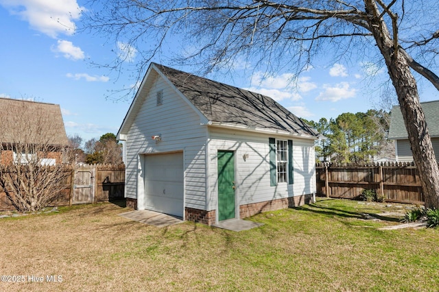 detached garage with driveway and fence