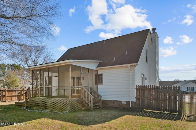 rear view of house with fence, roof with shingles, a yard, a sunroom, and a chimney