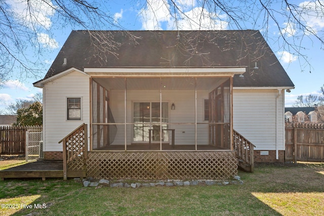 back of property with fence, a lawn, a sunroom, and a wooden deck