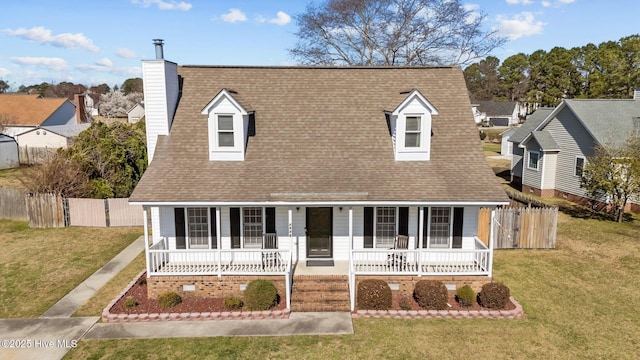 cape cod-style house with a porch, a shingled roof, and a front yard