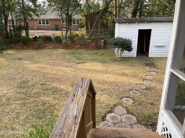 view of yard with an outdoor structure and fence