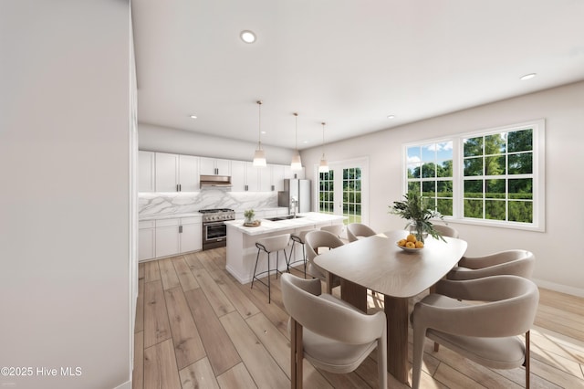 dining space with light wood-type flooring, recessed lighting, and baseboards