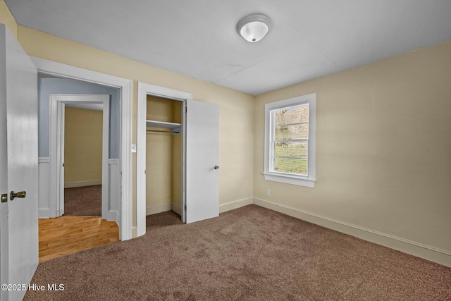 unfurnished bedroom featuring a closet and carpet floors