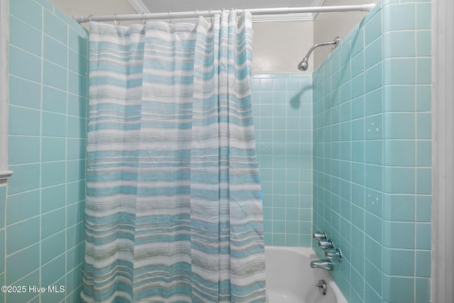 bathroom with shower / bath combo with shower curtain