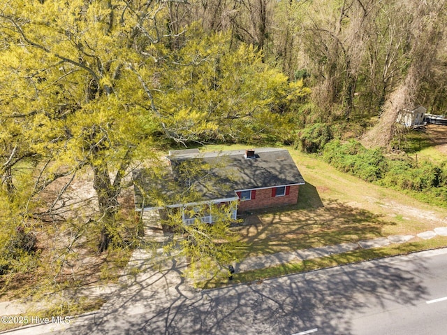 birds eye view of property with a wooded view