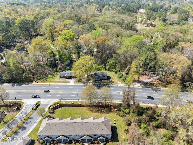 bird's eye view with a wooded view