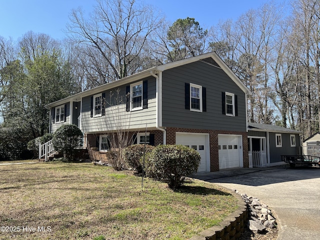 view of front facade with a front yard, a garage, brick siding, and driveway