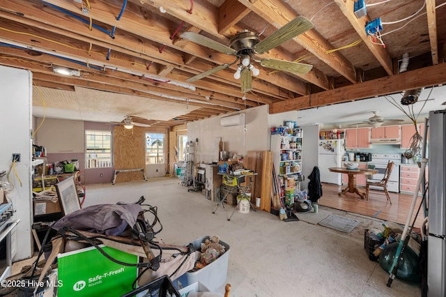 interior space featuring ceiling fan, a wall mounted AC, and freestanding refrigerator