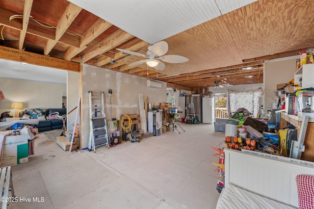 misc room featuring a wall unit AC, unfinished concrete flooring, and a ceiling fan