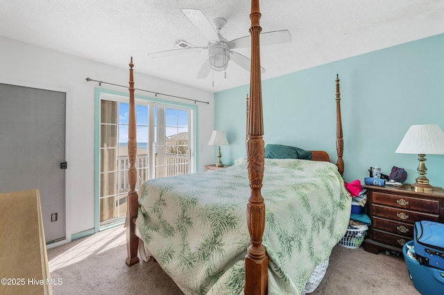 carpeted bedroom featuring a textured ceiling, access to exterior, and a ceiling fan