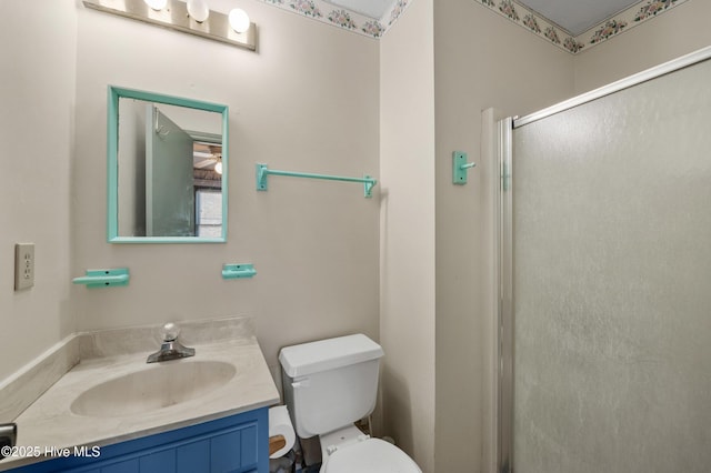 full bath featuring vanity, toilet, and a stall shower