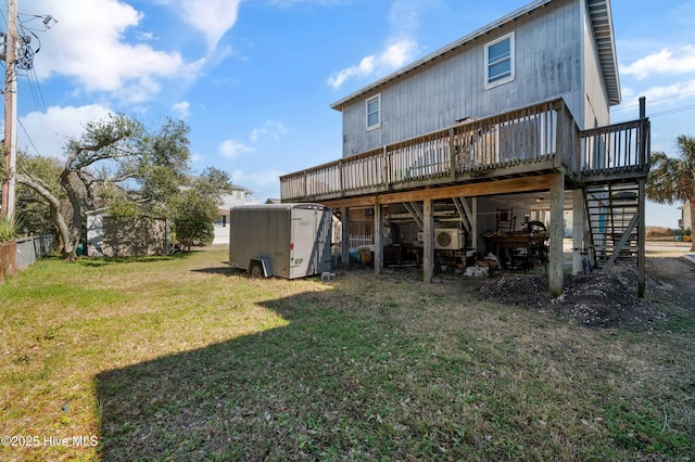 rear view of property with a yard, a shed, a wooden deck, and an outdoor structure